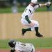 Eastern Michigan senior Tucker Rubino hops over Michigan sophomore Cole Martin after beating him to second base for the out at Eastern on Wednesday.  Melanie Maxwell I AnnArbor.com